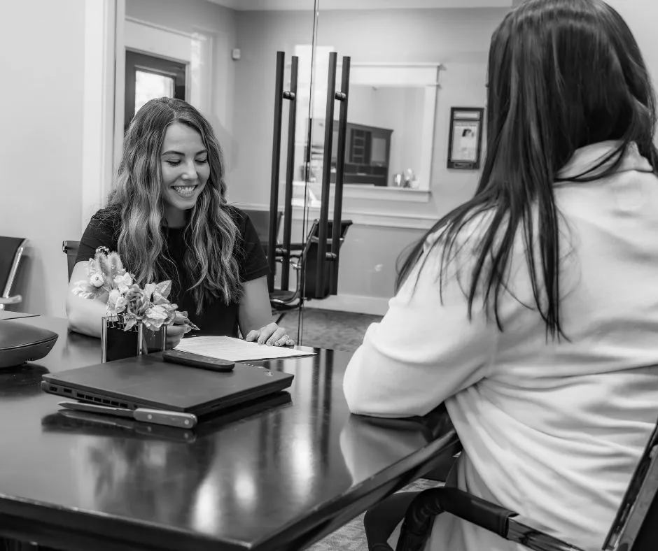 Two women at ANR Properties smiling during a business meeting.