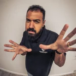 Mersad Rezaei of Manticore Marketing reaching toward a fisheye lens