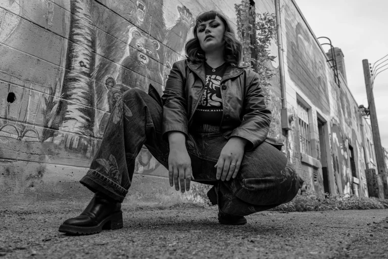 Manticore Marketing team member crouching in an alley, black and white