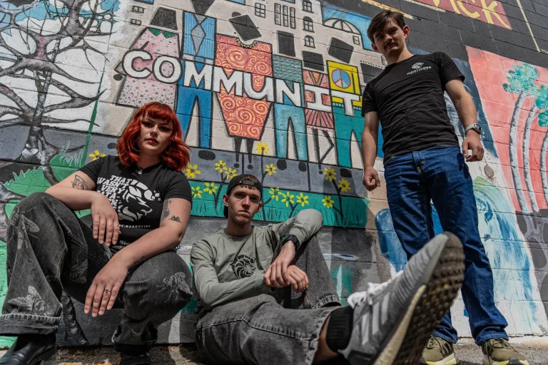 Manticore Marketing team in front of a Community mural