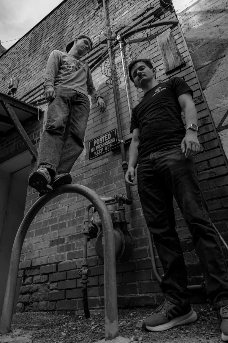 Manticore Marketing team posing on a brick fire escape, black and white