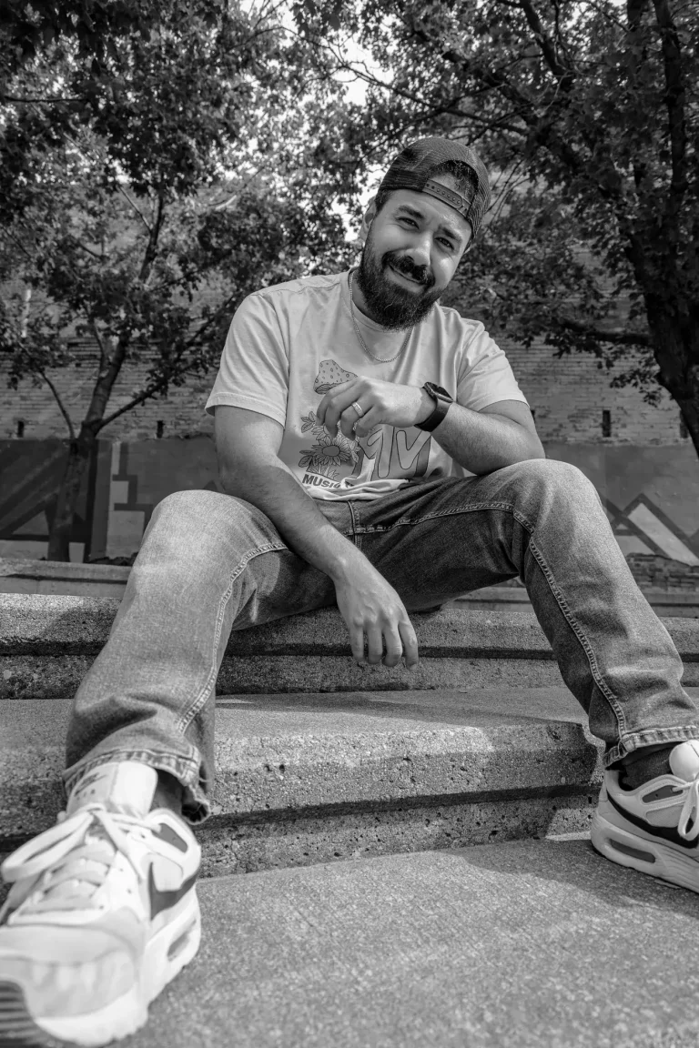 Manticore Marketing team member laughing on outdoor steps, black and white