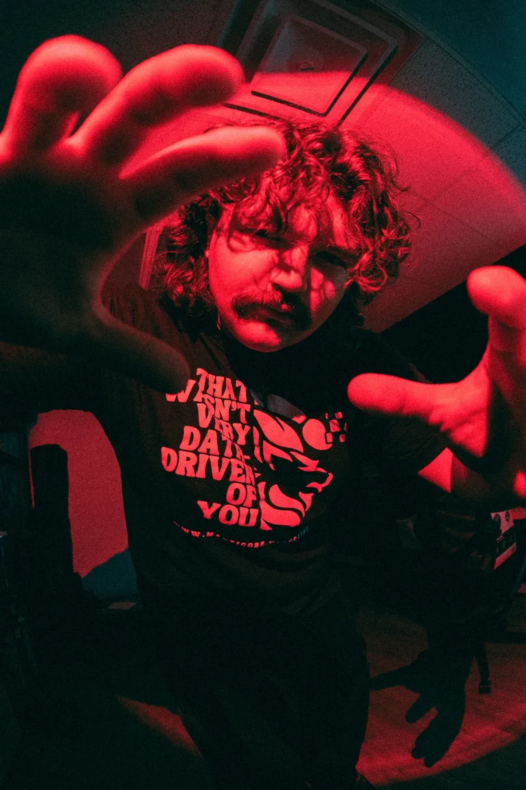 Manticore Marketing team member under red light, fisheye