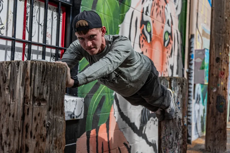 Manticore Marketing team member leaning on a tiger mural